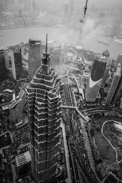 Breathtaking Aerial View above Jin Mao Tower in Shanghai, China surrounded by clouds Circa 2018