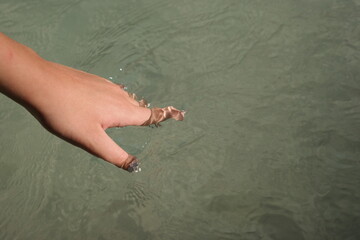 Hand in the river stream