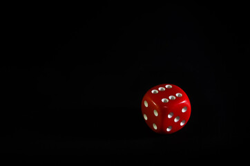 Old red dice isolated on black background with copy space.