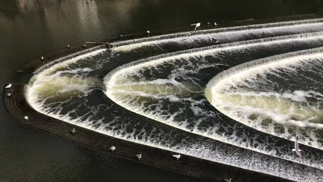 Water flowing over the Pulteney Weir on the River Avon, which runs through the centre of Bath