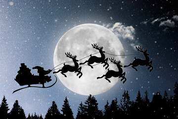 Naklejka premium Silhouette of Santa Claus flying on a sleigh with reindeer on the background of a large moon in snowy weather. Christmas card. Christmas, holiday, greetings.