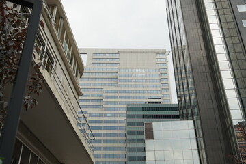 A cut out of several tall modern corporate buildings concentrated together. The photo is taken at low view angle.