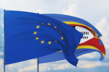 Waving European Union flag and flag of Eswatini. Closeup view, 3D illustration.