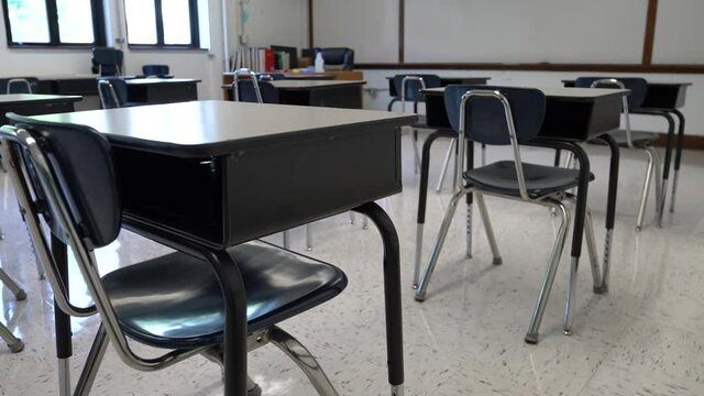 Motion to the left showing empty school classroom with chairs under desks. Concept for pandemic.