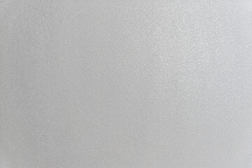 abstract background of an embossed painted grey wall close up
