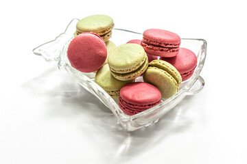 raspberry and pistachio macaroon cakes in a bell shaped glass bowl