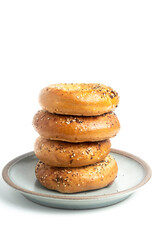 A Stack Of Four "Everything" Bagels On Ceramic Breakfast Plate