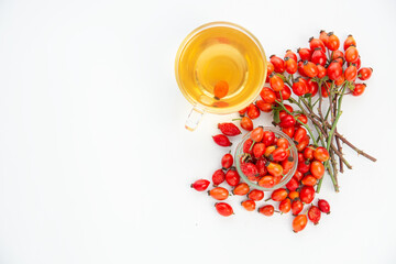 Dog rose, bunch branch Rosehips, types Rosa canina hips and herbal tea - Medicinal plants herbs...