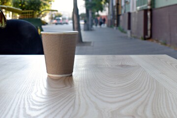 cup of coffee in blurred background of cityscape