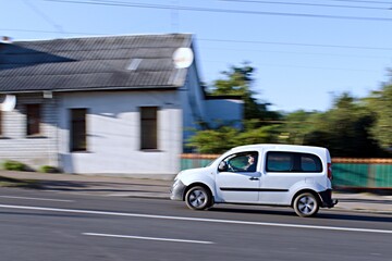 passenger white car in city traffic in blurred motion