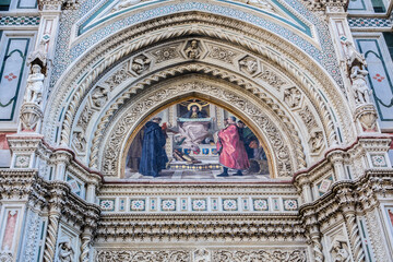 Fototapeta na wymiar Cathedral Santa Maria del Fiore (or Duomo di Firenze), was built between 1296 and 1436. Cathedral is one of largest in world. Architectural fragments of front facade. Piazza del Duomo, Florence, Italy