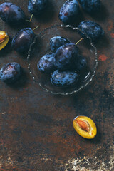 Ripe plums on a glass plate