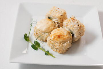 Four maki sushi rolls with salmon.