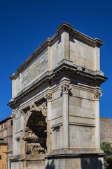 Fototapeta na wymiar Right next to Colosseum stands Arch of Constantine, erected in early fourth century to celebrate victory of Constantine over Emperor Maxentius. Arch decorated with statues and reliefs. Rome. Italy.
