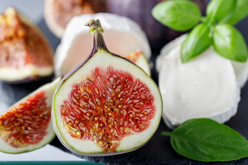 Fresh sweet figs and goat cheese on stone board