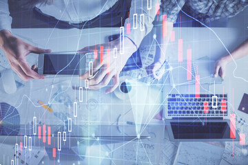 Double exposure of man and woman working together and financial chart hologram drawing. market analysis concept. Computer background. Top View.