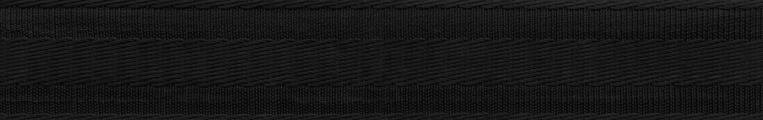 Black fabric strap texture band. Wide nylon elastic. Factory repeating stretch macro texture.Texture tug knitted.Belt sling.