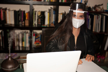 Covid-19 Pandemic new reality in the world woman following protection regulations with the use of a face mask and face mask in Mexico