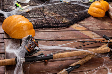 Fishing tacles on wooden background in Halloween designe with spaders and web