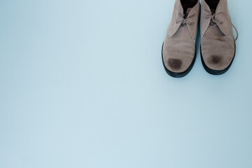 pair of suede shoes on a gray background