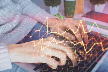 Double exposure of woman hands typing on computer and forex chart hologram drawing. Stock market invest concept.