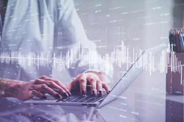 Double exposure of woman hands typing on computer and forex chart hologram drawing. Stock market...