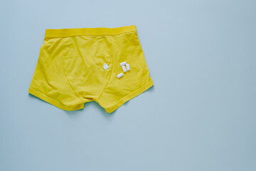 spot of chewing gum on yellow panties.isolated on gray background