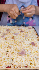elderly woman white mother cutting sausages and sausages to make pizza