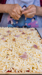 elderly woman white mother cutting sausages and sausages to make pizza