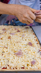 elderly woman white mother cutting sausages and sausages to make pizza