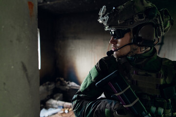 Fototapeta na wymiar Soldier in combat. Urban combat training, soldier entering abandoned building. Anti terrorist operation battlefield training.