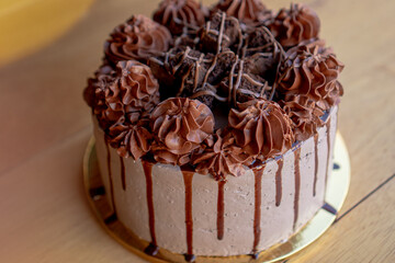Exquisite chocolate cake with chocolate cream and brownies on top.