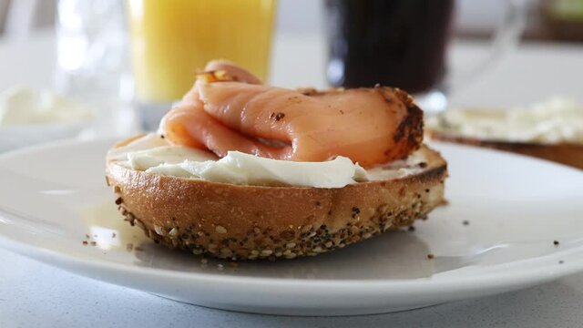 Adding Smoked Salmon to a Bagel with Cream Cheese