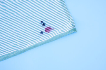 stain blueberry on the tablecloth.isolated on blue background