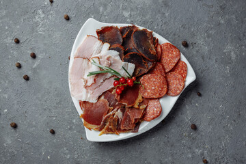 Mix of sliced meat on a white plate
