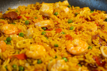 Sea Food Home made Paella Valenciana. Typical Spanish seafood paella in traditional pan. Macro close-up. Selective focus