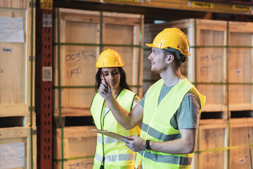 Multi ethnic warehouse worker in hardhat and vest work in cargo