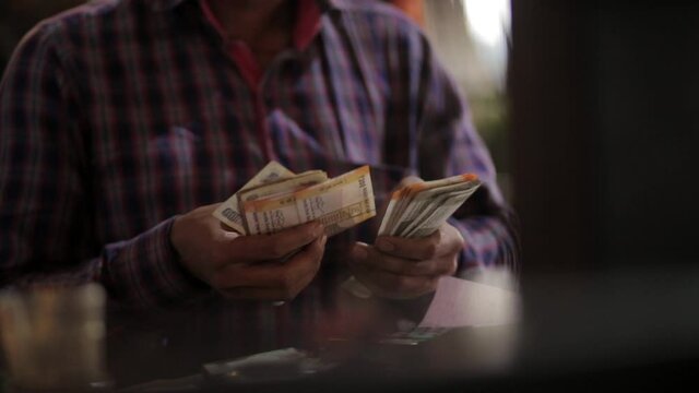counting currancy red shirt market seller.