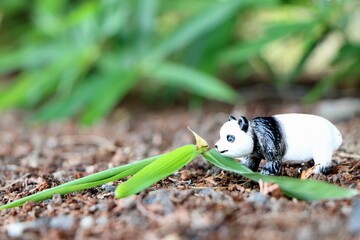 笹の葉の茂みのパンダのおもちゃ