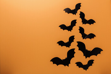 Halloween black paper bats on orange background. Top view Copy space - Image