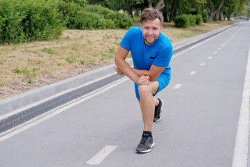 Handsome man jogging in the park. Sportsman runs exercising training outdoors.