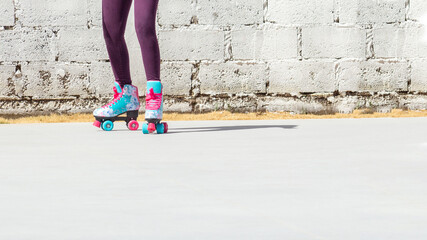 Legs of a girl with colorful roller skates