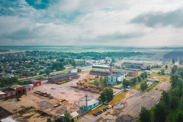 Atmospheric cityscape with a destroyed factory in Belarus. Rainy day with fog. Aerial view
