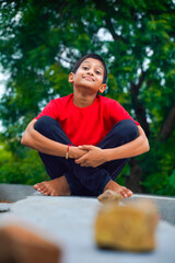 Happy indian child playing at ground