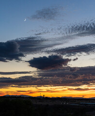 silhouette of a tower at sunset, orange sky with clouds