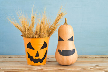 Halloween decoration ideas. Jack Oliver lantern buckets and wheat ears, Halloween pumpkin on wooden...