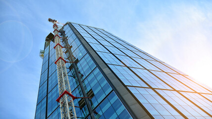 High-rise building under construction. Modern office building. Sunset