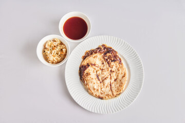 Pupusas from El Salvador dish isolated with curtido on a stylish white plate
