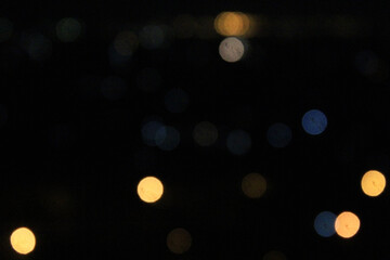 Blue and golden glitter lights in the dark, abstract blurred bokeh background. Defocused