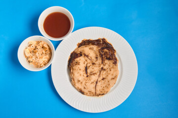Pupusas from El Salvador dish isolated with curtido on a stylish white plate